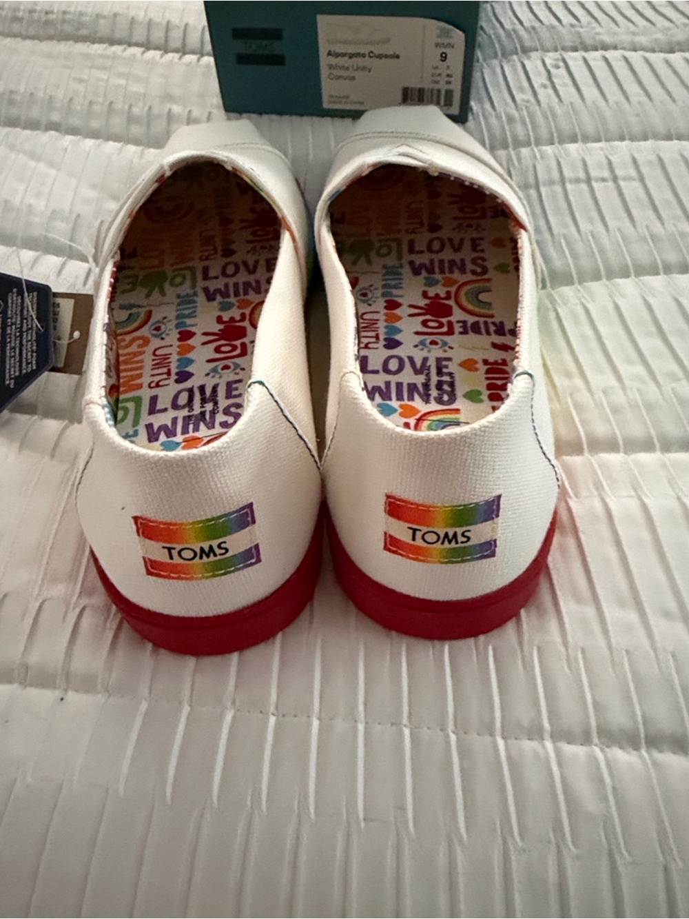 TOMS White Canvas Slip-Ons with Rainbow Pride Insole